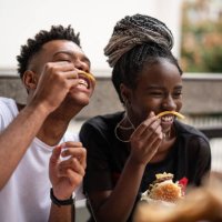 group of young people having fun in a restaurant - junk food stock pictures, royalty-free photos & images