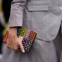 Guest holds a color book , outside Leonard, during Paris Fashion Week Womenswear Spring/Summer 2018, on October 2, 2017 in Paris, France.