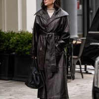 Guest is seen waring a brown trench coat, tan sweater, black bag and black sunglasses outside the Kallmeyer show during NYFW F/W 2025 on February 11,...