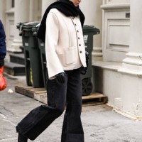Guest is seen waring a white jacket, black pants, black shoes and black scarf outside the Kallmeyer show during NYFW F/W 2025 on February 11, 2025 in...
