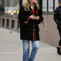 Guest is seen wearing a black and red Gucci jacket, blue jeans and red shoes with black sunglasses outside the Jason Wu show during NYFW F/W 2024 on...