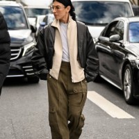 Guest is seen wearing a black jacket, cream jacket, white shirt, green cargo pants outside the Miu Miu show during the Womenswear Fall/Winter...