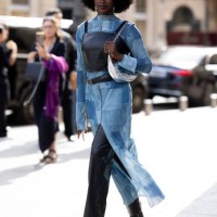 Guest is seen wearing a black leather tank top over a denim patchwork dress outside Giambattista Valli show during the Womenswear Spring/Summer 2024...