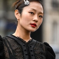 Guest is seen wearing a black ruffled sheer laced Rokh topand hair clip outside the Rokh show during the Womenswear Fall/Winter 2025/2026 as part of...