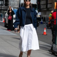 Guest is seen wearing a blue jacket, blue top, white skirt and white sandal outside the Carolina Herrera show during New York Fashion Week on...