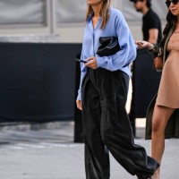 Guest is seen wearing a blue shirt, black bag , black pants and brown shoes outside the Michael Kors show during NYFW Spring/Summer 2025 on September...
