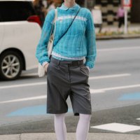 Guest is seen wearing a blue top, grey shorts, white tights, Onitsuka Tiger white sneakers during Rakuten Tokyo Fashion Week A/W 2025 on March 22,...