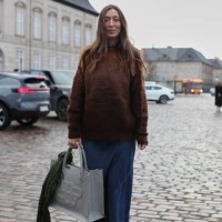 Guest is seen wearing a Brown Jumper with a Long Denim Skirt at Cmmn Swdn. During the Copenhagen Fashion Week Autumn/Winter 2025 on January 30, 2025...