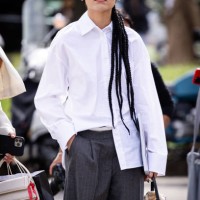 Guest, is seen wearing a oversize white shirt and grey trousers outside Fendi show during the Milan Fashion Week Menswear Spring/Summer 2025 on...