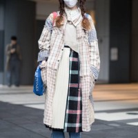 Guest is seen wearing a patchwork plaid coat, plaid skirt and torn blue jeans during the Amazon Fashion Week TOKYO 2018 A/W on March 22, 2018 in...
