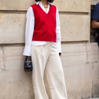 Guest is seen wearing a red sweater vest over a white button shirt and wide pants outside Marni show during the Womenswear Spring/Summer 2024 as part...