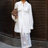 Guest is seen wearing a white shirt, white bra top, white lace skirt, brown heels and carrying a brown bagoutside the Patbo show during New York...