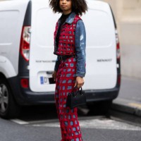 Guest is seen wearing black leather shoes, a black leather bag, a black belt, a black top and a red fishnet and blue jeans coord-set made of a...