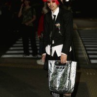 Guest is seen wearing white shirt, black jacket, shorts, Converse sneakers, silver bag during Rakuten Tokyo Fashion Week S/S 2025 on September 07,...