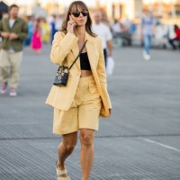 Guest is seen wearing yellow blazer, shorts, black Dior bag outside Ganni during Copenhagen Fashion Week Spring/Summer 2023 on August 11, 2022 in...
