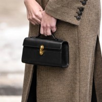 Guest is seen with a black and gold buckle bag outside the Ulla Johnson show during NYFW F/W 2025 on February 09, 2025 in New York City.