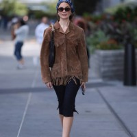 Guest seen wearing a blue pattern bandana headband, gold round earrings, DMY Studios black oval sunglasses, vintage brown suede leather jacket with...