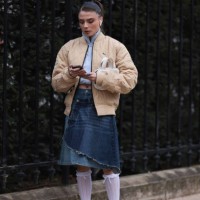 Guest seen wearing a yellow step jacket, white pullover, blue denim Lacoste jeans skirt, white high socks, white sneaker and a white leather bag...