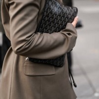 Guest wearing a tan jacket and skirt and black Louis Vuitton handbag outside the Ashlyn show during NYFW F/W 2025 on February 07, 2025 in New York...