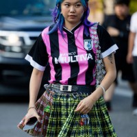 Guest wearing Miu Miu skirt, football jersey outside Collina Strada on September 09, 2022 in New York City.