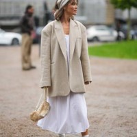 Guest wears a beige silk scarf as a headband, a white long dress, a beige oversized blazer jacket, a beige and white latte striped print pattern...