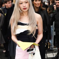Guest wears a black and white top, a pink skirt a white Miu Miu bag outside Miu Miu show during the Womenswear Fall/Winter 2025/2026 as part of Paris...