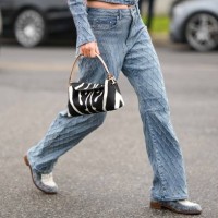 Guest wears a blue faded denim embroidered checkered pattern zipper jacket, matching blue faded denim embroidered checkered pattern large pants, a...