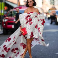 Guest wears a bridal face veil, a red and white off-shoulder floral print pattern midi on-knee and long dress with printed polka dots, white platform...