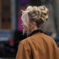 Guest wears a brown jacket, earrings, outside Miu Miu, during the Womenswear Spring/Summer 2024 as part of Paris Fashion Week on October 03, 2023 in...