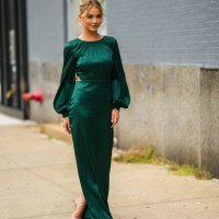 Guest wears a dark green zebra print pattern puffy long sleeves long dress, beige heels sandals, during New York Fashion Week, on September 11, 2022...