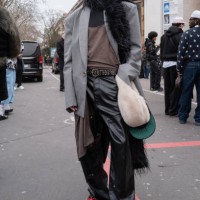 Guest wears a grey oversized blazer a black pants black belt and red shoes outside Rick Owens during the Menswear Fall Winter 2025/2026 as part of...