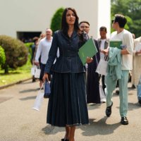 Guest wears a navy blue fitted and lined blazer jacket, navy blue pleated denim jean midi skirt, black Dior leather bag, shiny black with black bows...