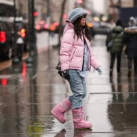 Guest wears a pale gray blue oversized fluffy hat, a pale pink hoodie puffer jacket, a baby blue shirt, blue faded denim large jeans ripped pants, a...