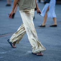 Guest wears a pale khaki tank-top, a pink and black leopard print pattern cotton shoulder bag, gold velvet large pants, black flip flop from...