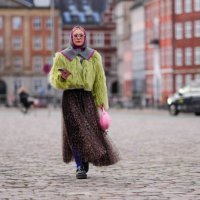Guest wears a purple and gray ribbed wool balaclava / hood, a yellow / green fluffy oversized jacket , a flowing tulle leopard print pattern gathered...