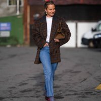 Guest wears a red hair scrunchie, earrings, a white t-shirt, a brown checkered / checked pattern printed oversized blazer jacket, a brown leather...