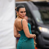 Guest wears a teal dress with thin straps and intricate floral embroidery detailing on the back. The dress features a fitted silhouette. Large gold...