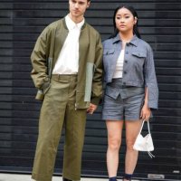Guest wears a white shirt, a green oversized khaki jacket, matching pants, black leather shoes ; a guest wears a blue denim jacket, a white low-neck...