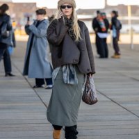 Guest wears beige head band, brown bag, green skirt, bag outside OpéraSport during the Copenhagen Fashion Week AW24 on January 31, 2024 in...