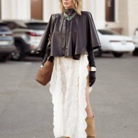 Guest wears beige mini skirt, long beige boots, white long lace skirt, dark brown leather jacket, black leather gloves and brown bag during the 10th...