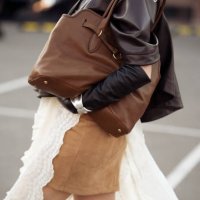 Guest wears beige mini skirt, white long lace skirt, dark brown leather jacket, black leather gloves and brown bag during the 10th season of the Visa...