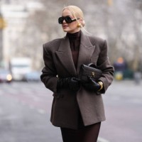 Guest wears black Altuzarra sunglasses, gold earrings, deep dark brown turtleneck long sleeve form fitting midi dress, dark brown oversized double...