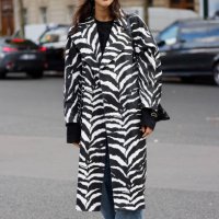 Guest wears black and white zebra print coat, outside Miu Miu, during Womenswear Spring/Summer 2025 as part of Paris Fashion Week on October 01, 2024...