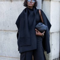 Guest wears black cape, shorts outside Cos during New York Fashion Week on September 10, 2024 in New York City.