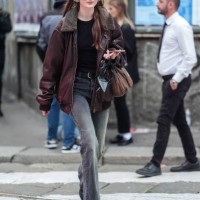 Guest wears black glasses, black t-shirt, black leather belt, washed black denim jean skinny pants, black dark brown fluffy collar oversized leather...