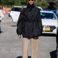 Guest wears black jacket, beige pants outside Ulla Johnson New York Fashion Week on September 08, 2024 in New York City.