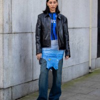 Guest wears black leather jacket, blue Inter Milan shirt, dress outside Conner Ives during London Fashion Week February 2024 on February 18, 2024 in...