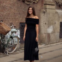 Guest wears black long dress and cow print ballerina shoes outside the Gestuz show during day four of the Copenhagen Fashion Week SS25 on August 08,...