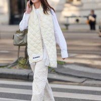 Guest wears black sunglasses, a white shirt, a pale yellow quilted puffy large scarf from Jil Sander, a khaki matte leather Puzzle handbag from...
