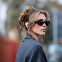 Guest wears black sunglasses, dark gray blazer coat, outside Diesel, during the Milan Fashion week Women's Fall/Winter 2025-2026 on February 26, 2025...